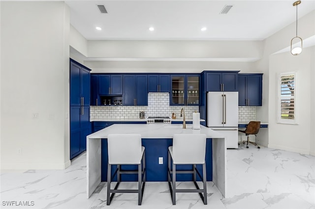 kitchen featuring a kitchen island with sink, a kitchen bar, light stone counters, hanging light fixtures, and premium appliances