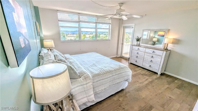 bedroom with baseboards, ceiling fan, access to exterior, and light wood-style floors