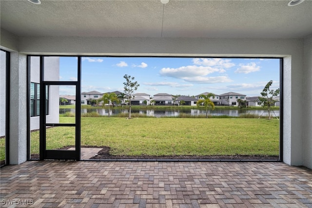 unfurnished sunroom with a water view and a wealth of natural light