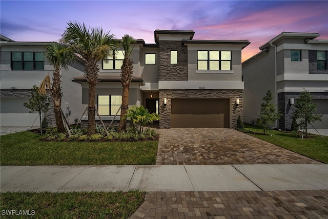 view of front of house featuring a garage and a yard