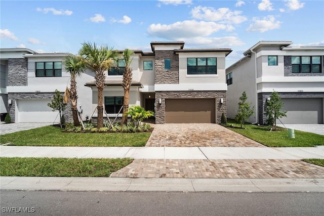 view of front of property featuring a front yard and a garage