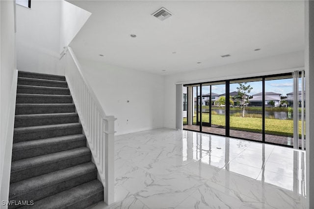 staircase featuring a water view