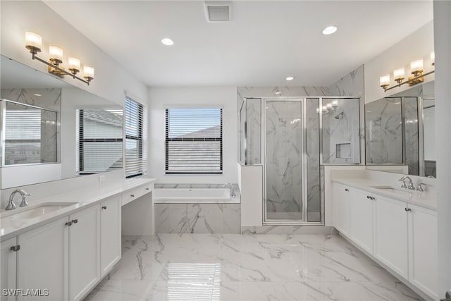 bathroom with vanity and separate shower and tub