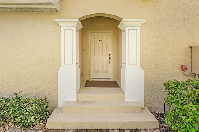 view of exterior entry with stucco siding