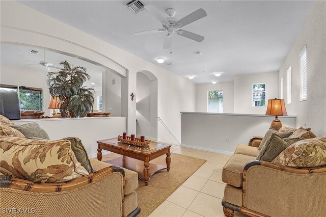 living room featuring light tile patterned flooring and ceiling fan