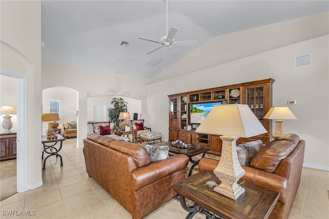 living room featuring light tile patterned floors, visible vents, arched walkways, and a ceiling fan