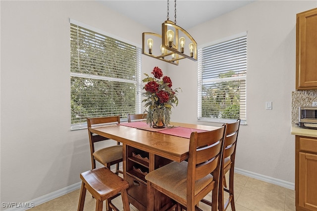 dining room with light tile patterned floors and baseboards