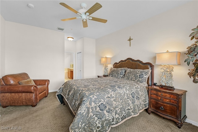 bedroom featuring a ceiling fan, carpet, visible vents, baseboards, and ensuite bath