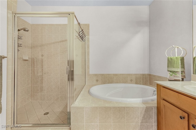 bathroom featuring vanity and shower with separate bathtub