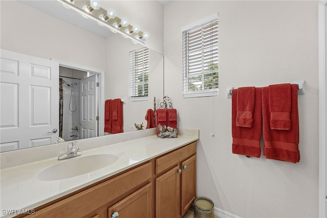 bathroom featuring vanity and tiled shower