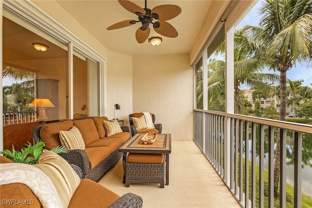 balcony with an outdoor living space and ceiling fan