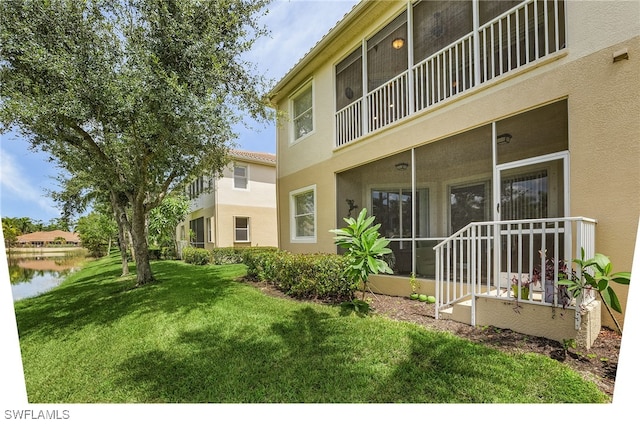 view of yard with a water view and a balcony