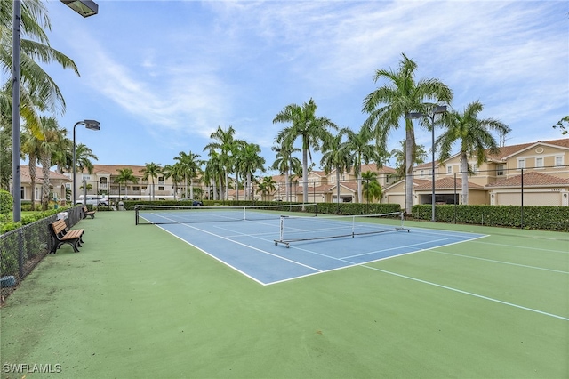 view of sport court featuring a residential view and fence