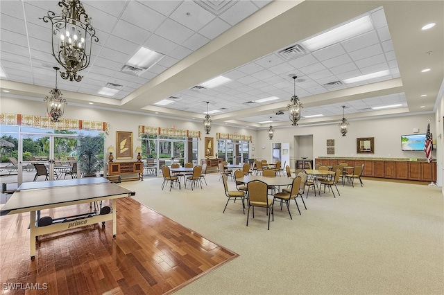 dining room with plenty of natural light, wood-type flooring, and a paneled ceiling