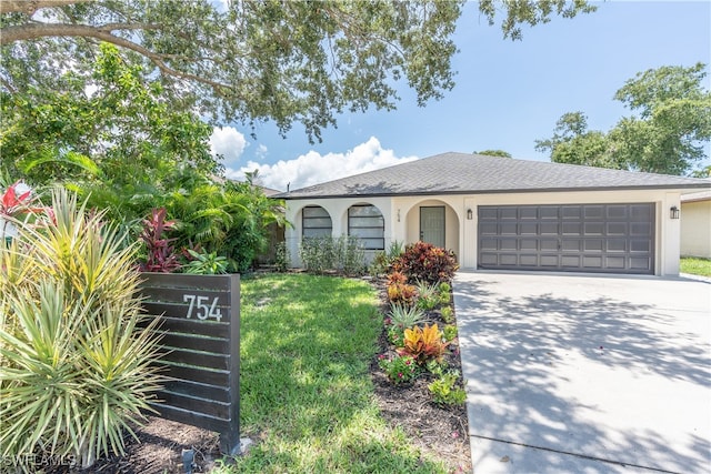 view of front of house with a garage and a front lawn