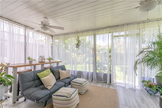 sunroom featuring ceiling fan, a wealth of natural light, and wooden ceiling