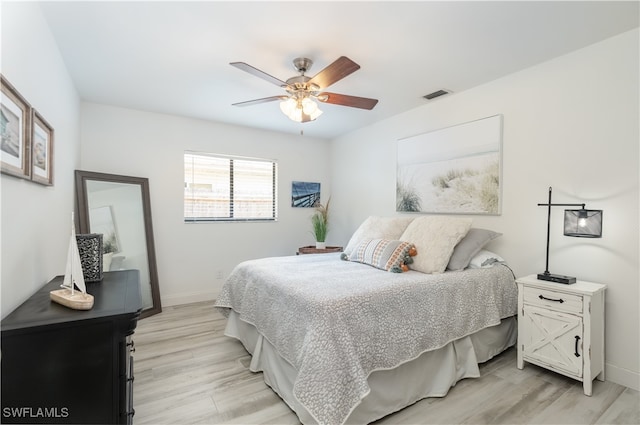 bedroom with ceiling fan and light hardwood / wood-style floors