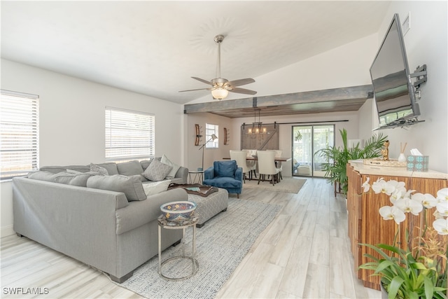 living room featuring light hardwood / wood-style flooring, ceiling fan, and vaulted ceiling