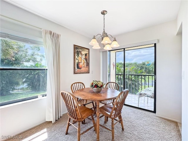 carpeted dining area featuring a wealth of natural light and a chandelier