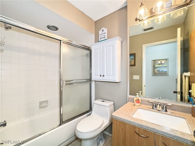 full bathroom with vanity, toilet, and enclosed tub / shower combo