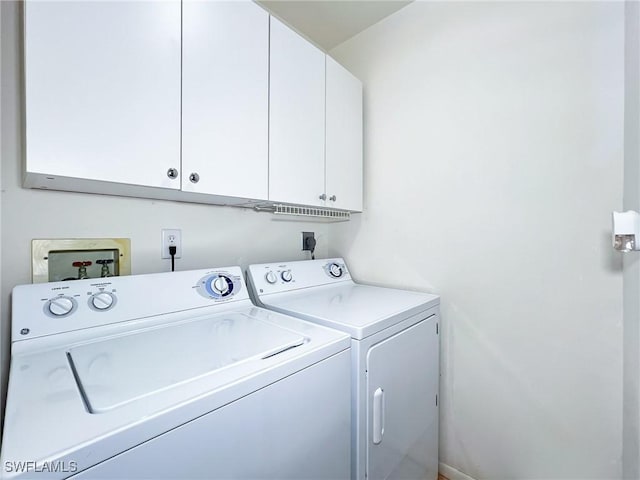 washroom with cabinets and separate washer and dryer