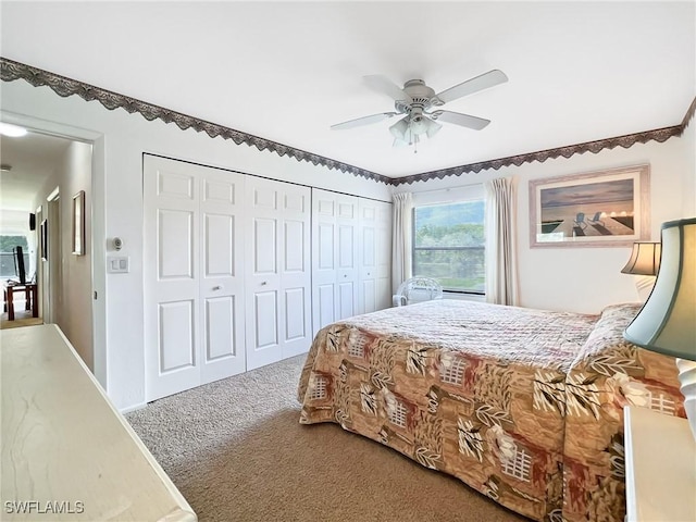 carpeted bedroom with ceiling fan and a closet