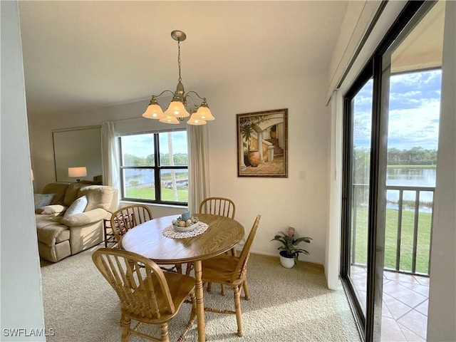 13276 White Marsh Ln Unit 3522, Fort Myers, FL 33912 - dining space featuring a water view, light carpet, and an inviting chandelier