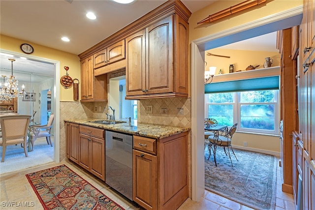 kitchen with light stone counters, tasteful backsplash, dishwasher, sink, and a chandelier