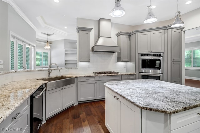 kitchen with gray cabinets, premium range hood, stainless steel appliances, and sink