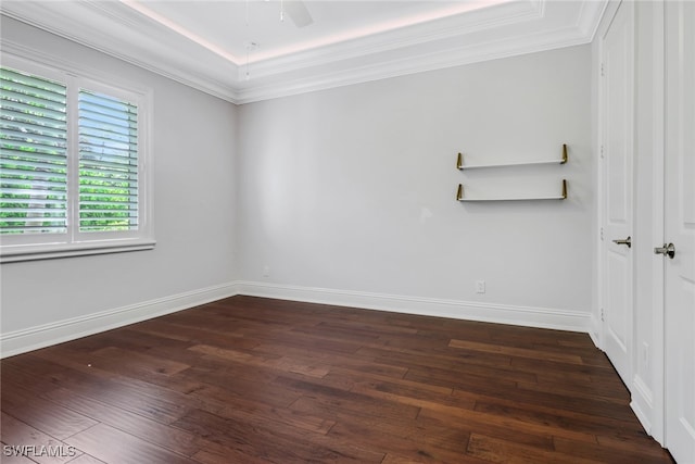 spare room with crown molding, dark hardwood / wood-style floors, and ceiling fan