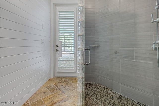 bathroom with a shower with door