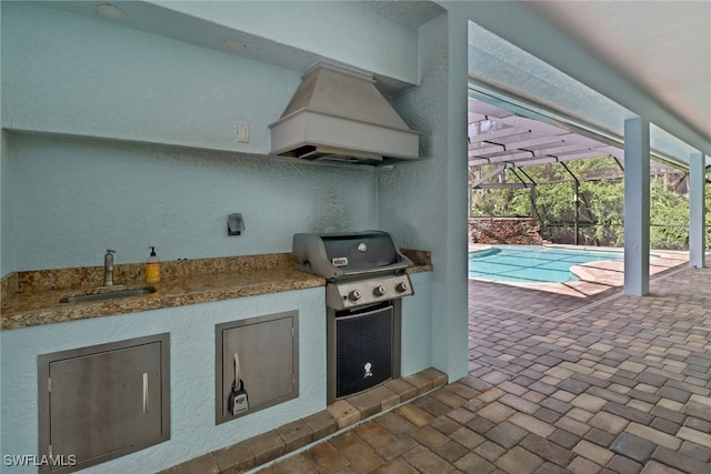 view of patio / terrace with glass enclosure, sink, and a grill