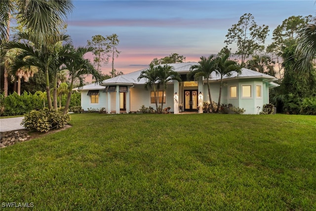 ranch-style house featuring a lawn