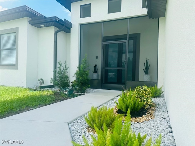 3713 25th St SW, Lehigh Acres, FL 33976 - doorway to property featuring stucco siding