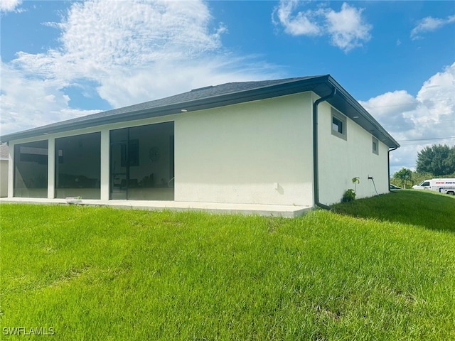 3713 25th St SW, Lehigh Acres, FL 33976 - rear view of house featuring stucco siding and a lawn