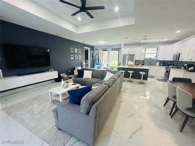 3713 25th St SW, Lehigh Acres, FL 33976 - living area with a ceiling fan, recessed lighting, a tray ceiling, and marble finish floor