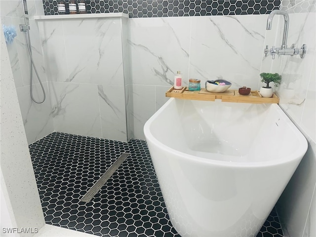 bathroom featuring plus walk in shower and tile walls