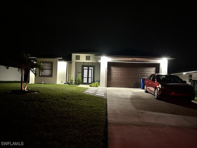 3713 25th St SW, Lehigh Acres, FL 33976 - prairie-style house featuring a garage, stucco siding, driveway, and a yard