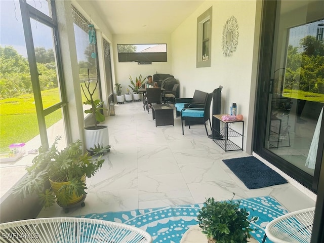 sunroom / solarium featuring a wealth of natural light