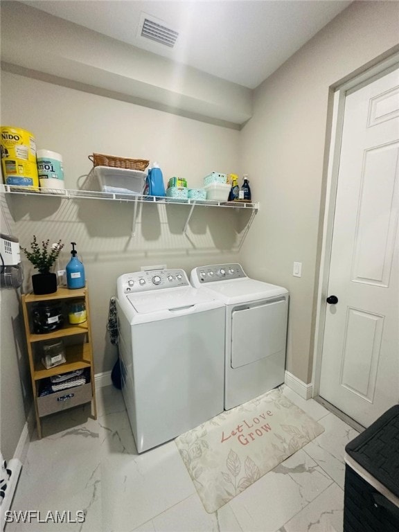 3713 25th St SW, Lehigh Acres, FL 33976 - laundry area with visible vents, laundry area, baseboards, washer and clothes dryer, and marble finish floor