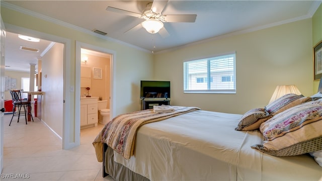 bedroom with light tile patterned flooring, connected bathroom, ceiling fan, and ornamental molding