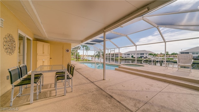 view of swimming pool with a patio area, an in ground hot tub, a lanai, and a water view