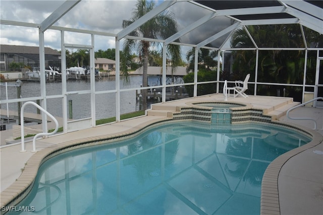 view of swimming pool featuring an in ground hot tub, a lanai, a water view, and a patio area