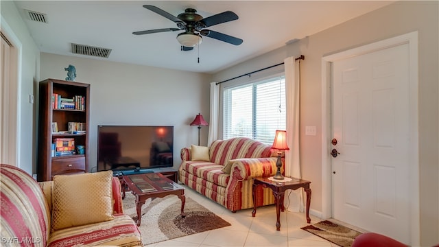 tiled living room featuring ceiling fan