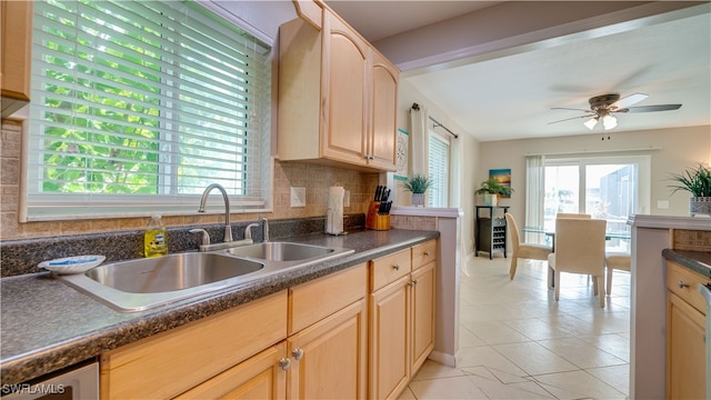 kitchen featuring ceiling fan, light brown cabinetry, sink, backsplash, and light tile patterned flooring