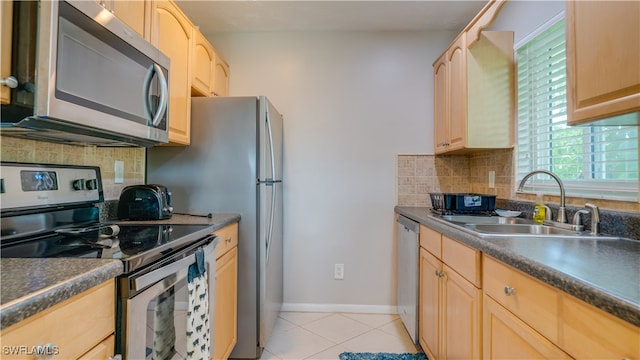 kitchen featuring light tile patterned floors, sink, backsplash, stainless steel appliances, and light brown cabinets