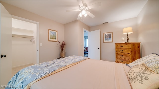 tiled bedroom featuring a closet and ceiling fan