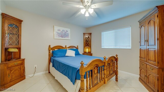 tiled bedroom with ceiling fan