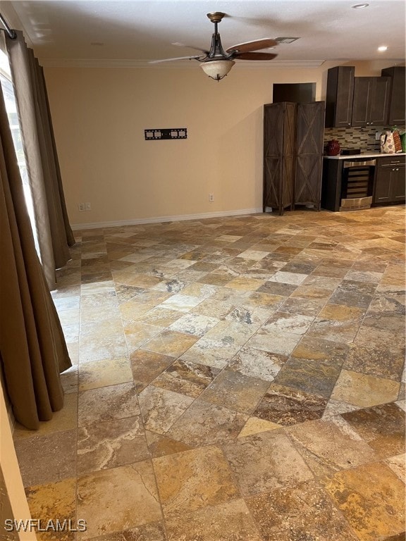 interior space with ornamental molding, wine cooler, and ceiling fan