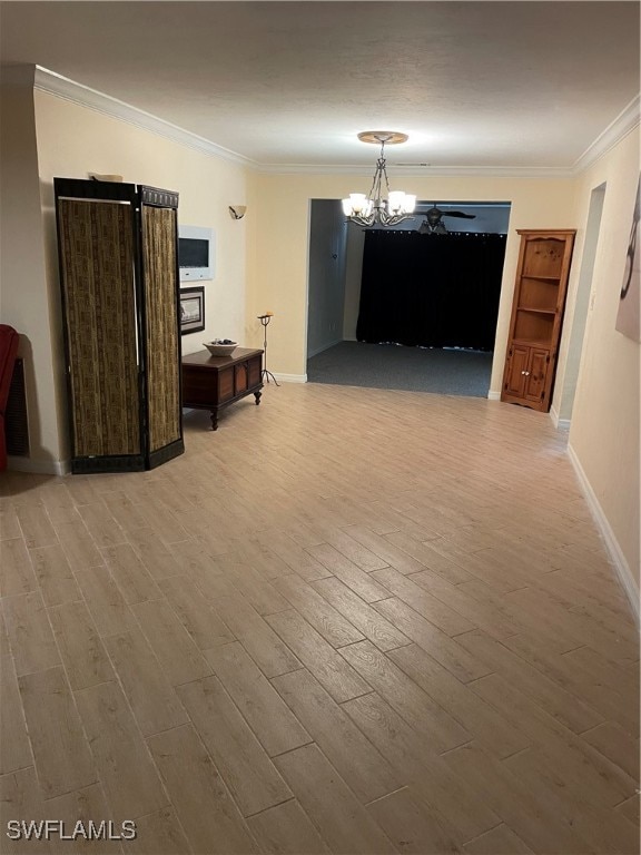 interior space featuring crown molding, a notable chandelier, and hardwood / wood-style floors